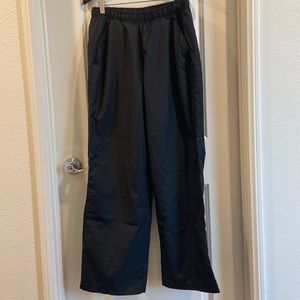Champion black pants with zipper opening at ankles.